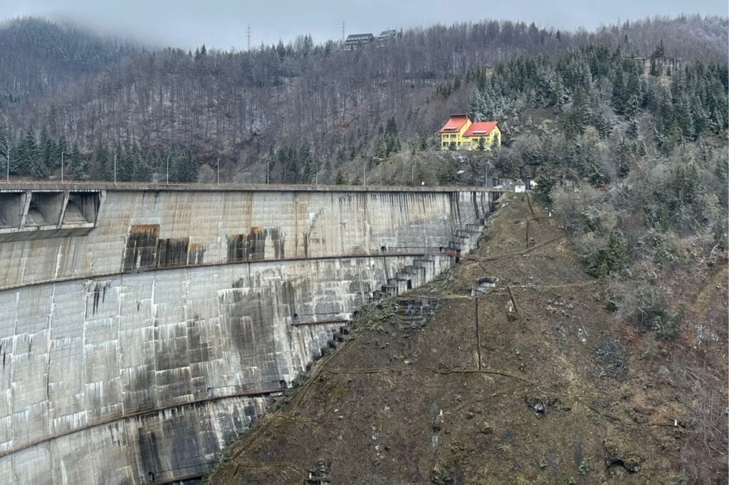 zapora na rzece w Rumunii. w tle zdjęcia widoczny las